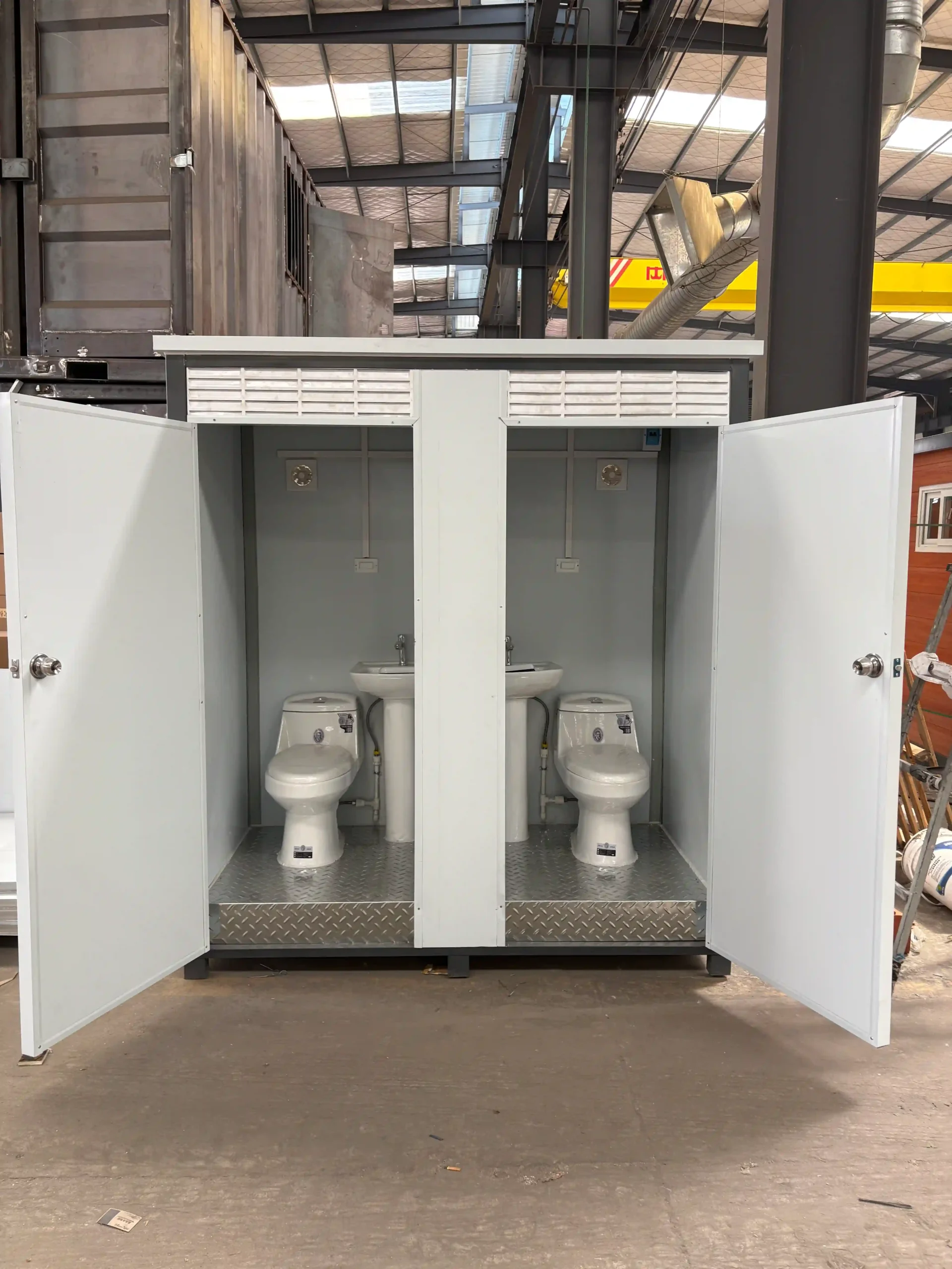 prefab bathroom，There are two toilets and a sink.